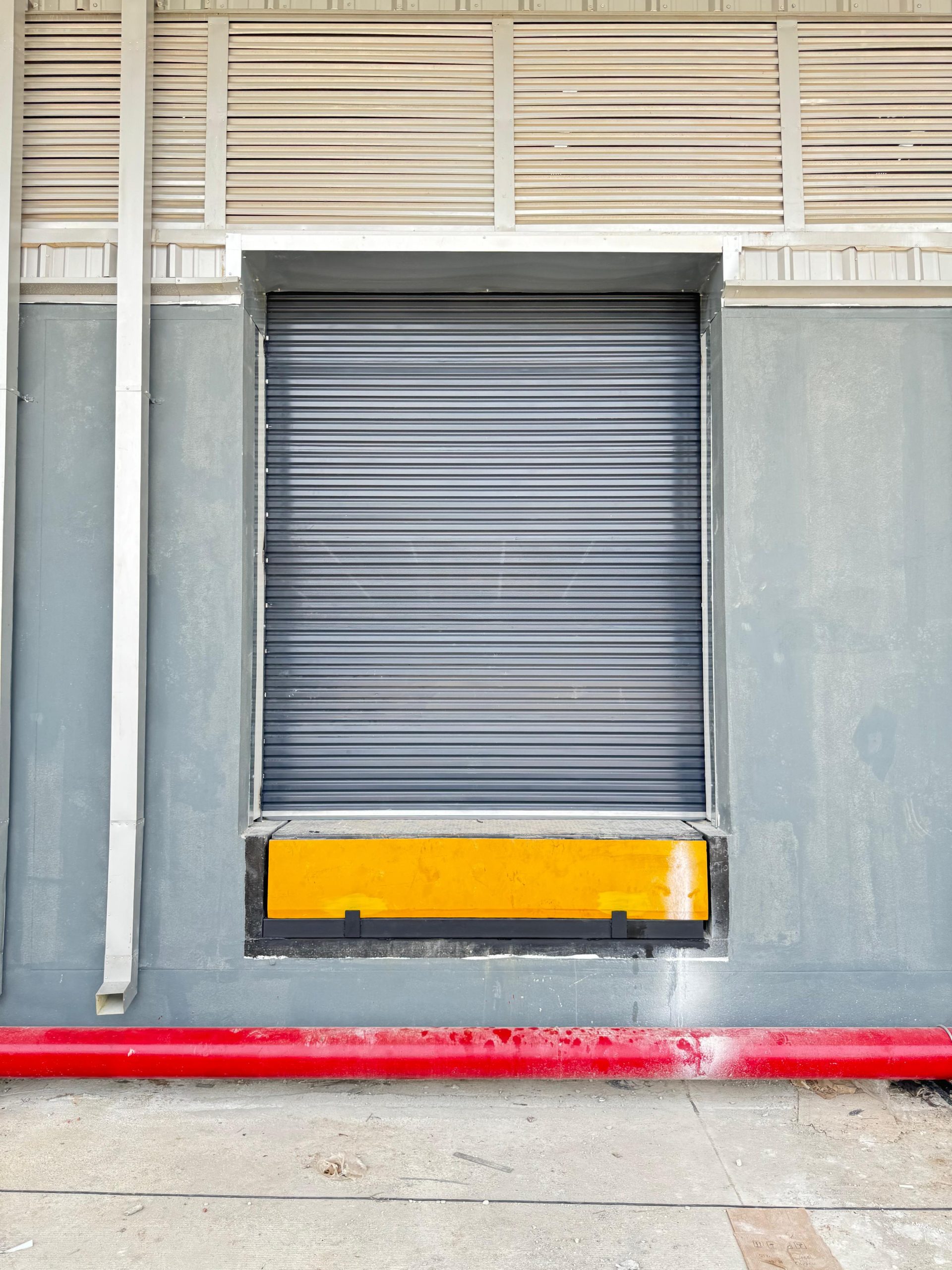 Industrial dock leveller and loading-bay shutter