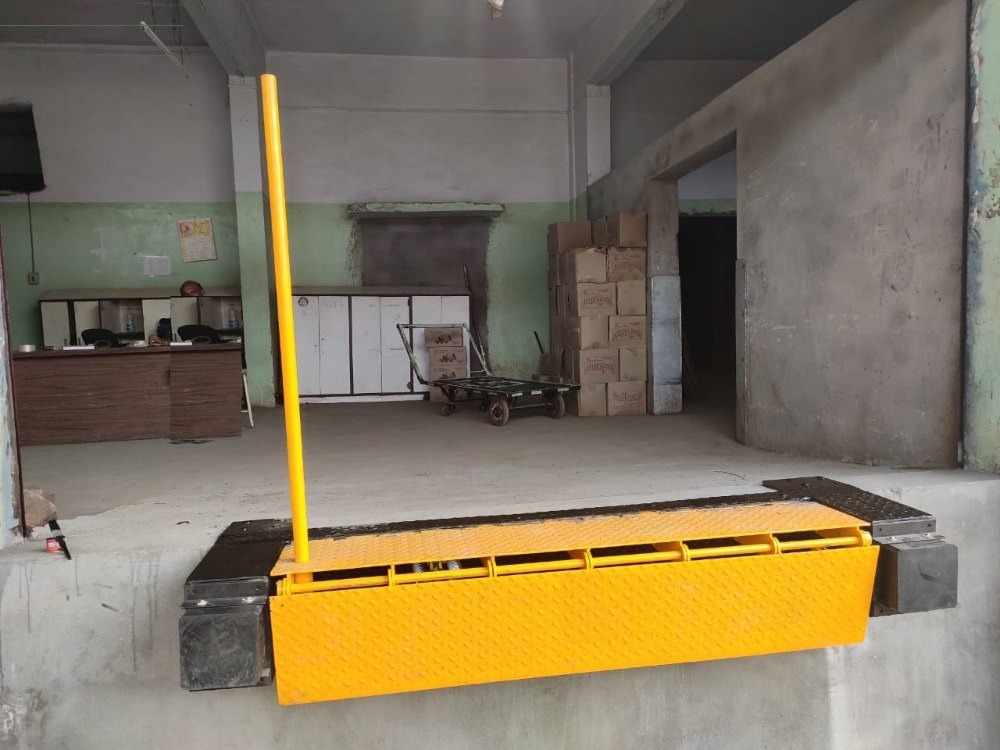 Yellow edge dock leveller installed at a loading bay