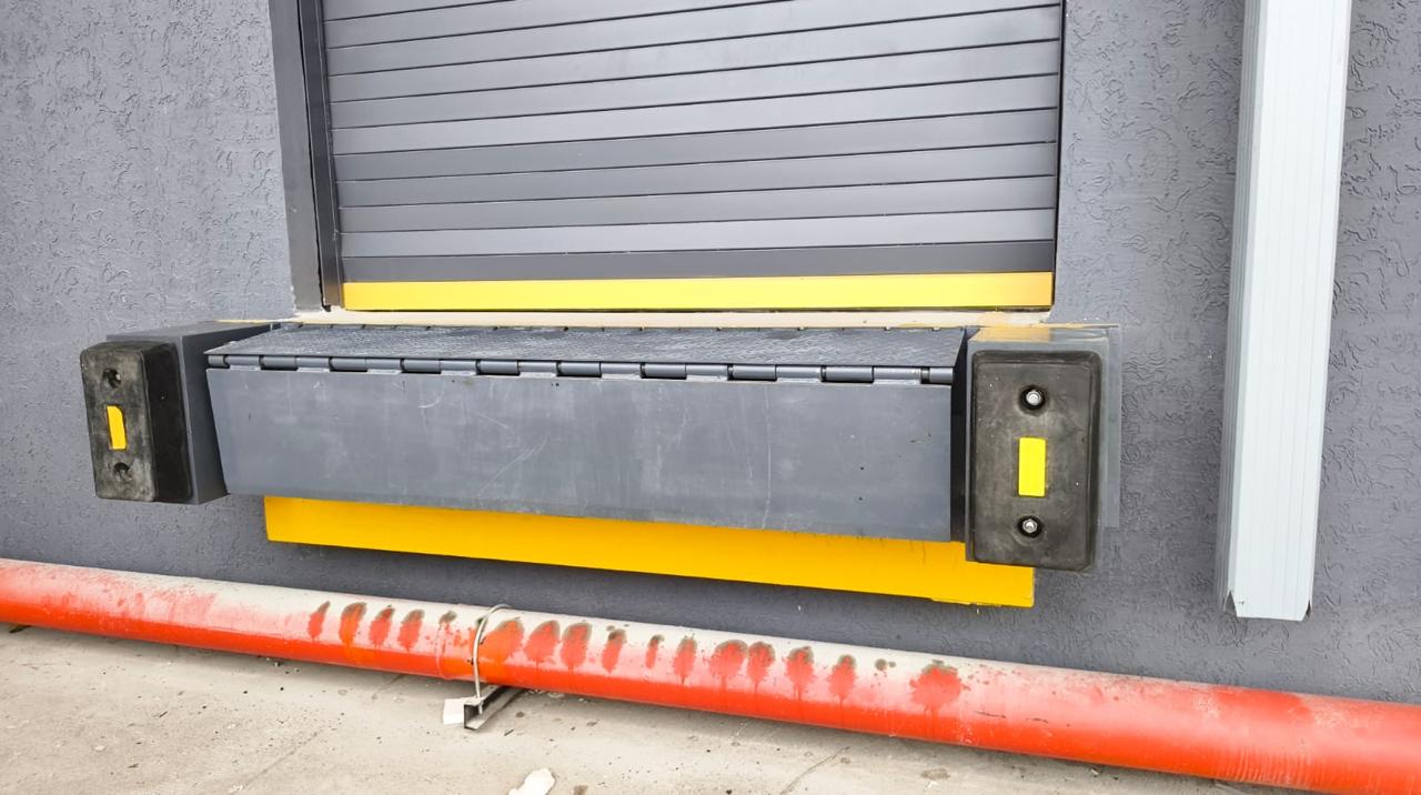 Edge dock leveller with dock bumpers